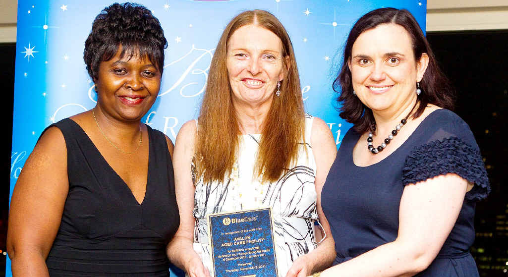 Emerald Blue Care clinical nurse Rose Chibanda and service manager Lea Magin accept the award from UnitingCare Queensland board chairwoman Heather Watson. Emerald Blue Care clinical nurse Rose Chibanda and service manager Lea Magin accept the award from UnitingCare Queensland board chairwoman Heather Watson.